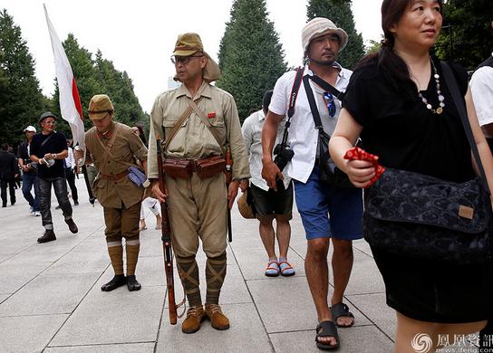 Some Japanese citizens wander around Yasukuni Shrine wearing old Imperial Japanese Army uniforms.
