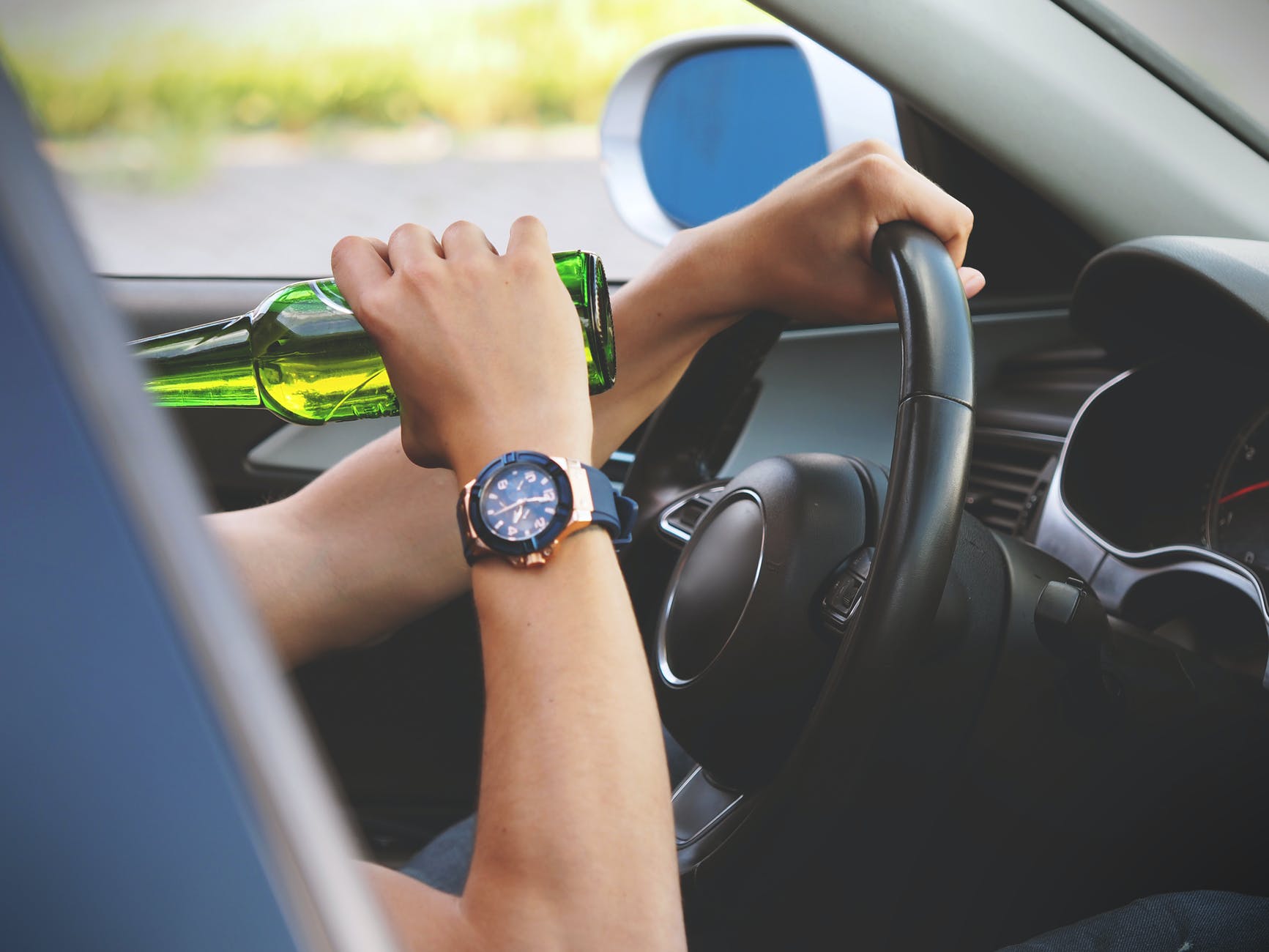person driving and drinking